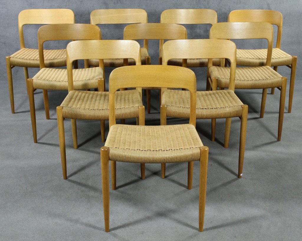 Set of 10 J.L. Møller Dining Chairs: Niels O. Møller (1920-1981). With low curved backrests. In blonde oak with hand-woven cord seats. Marked "J.L. Møller Models / In Denmark." 39 1/2" H. x 18 1/2" W.