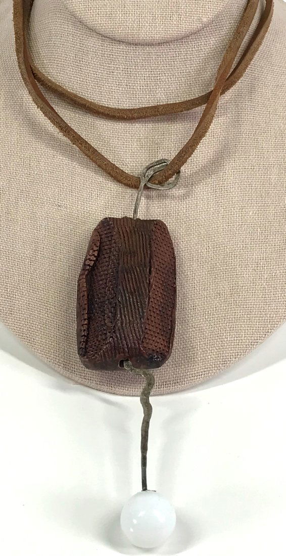 Vintage Brutalist Artsy Boho Necklace.: Vintage Brutalist Artsy Boho Plastic Bead, Lined in Leather & metal large pendant.Leather strap necklace. Unmarked. For measures please refer to the picture taken with a measure tape. Weight: 59 Grams