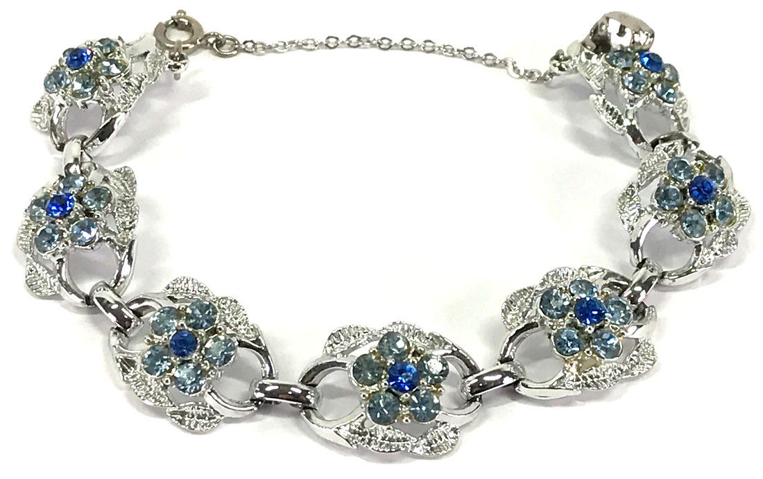 Vintage Coro crystals silvertone flowers & leaves bracelet.: Vintage Coro blue & sky blue crystals silvertone metal flowers & leaves bracelet. Marked Coro. Security chain.br>For measures please refer to the picture taken with a measuring tape. Weight: 22 Grams.