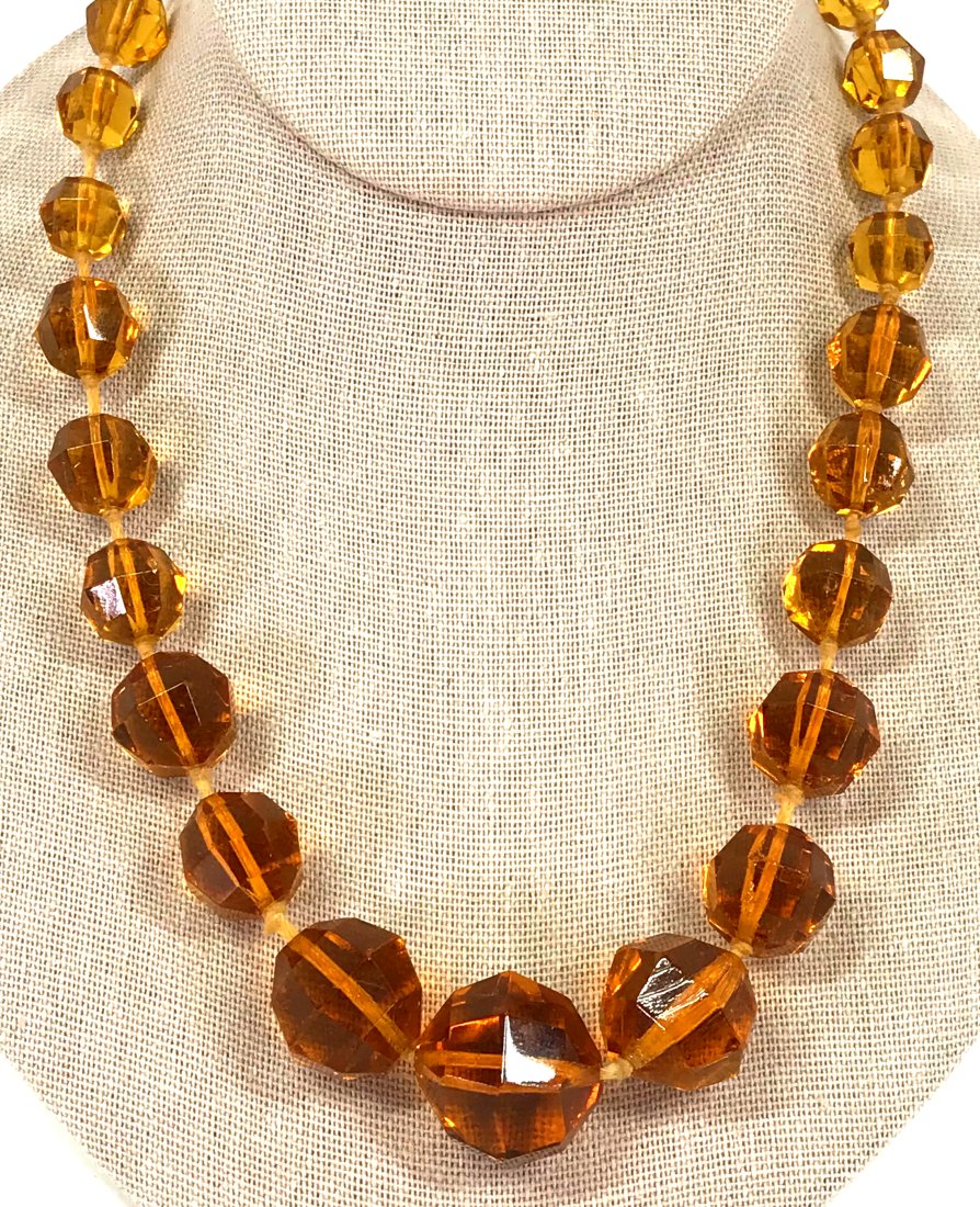 Antique Art Deco Amber Color Glass Collar Necklace.: Antique art deco amber color glass collar necklace. Faceted and graduated beads hand knotted in between with a golden clasp. It measures 18 1/4 inches long end to end. For measures please refer to the