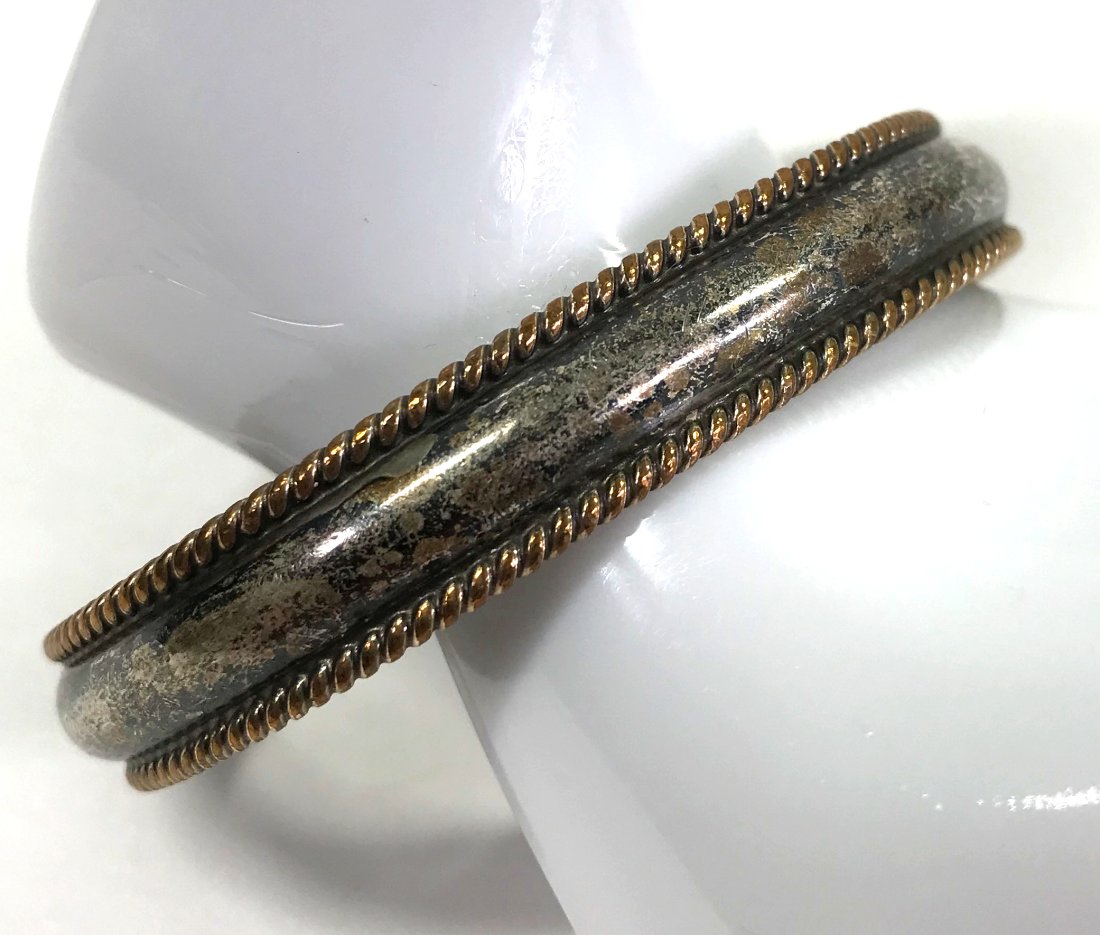 Navajo Tahe Sterling 12K Gold Filled Rope Cuff: Vintage Navajo Tahe sterling silver with 12K gold filled rope trims cuff bracelet. Marked Tahe sterling 1/20 12K G.F. It measures around 6 1/4 inches of interior circumference and 3/8 inch widest. Wei