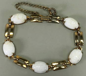Vintage egyptian revival white glass scarabs goldtone bracelet.: Vintage egyptian revival milky white glass scarabs beads goldtone metal bracelet. Security chain. Unmarked. For measures please refer to the picture taken with a measuring tape. Weight: 15 Grams. This