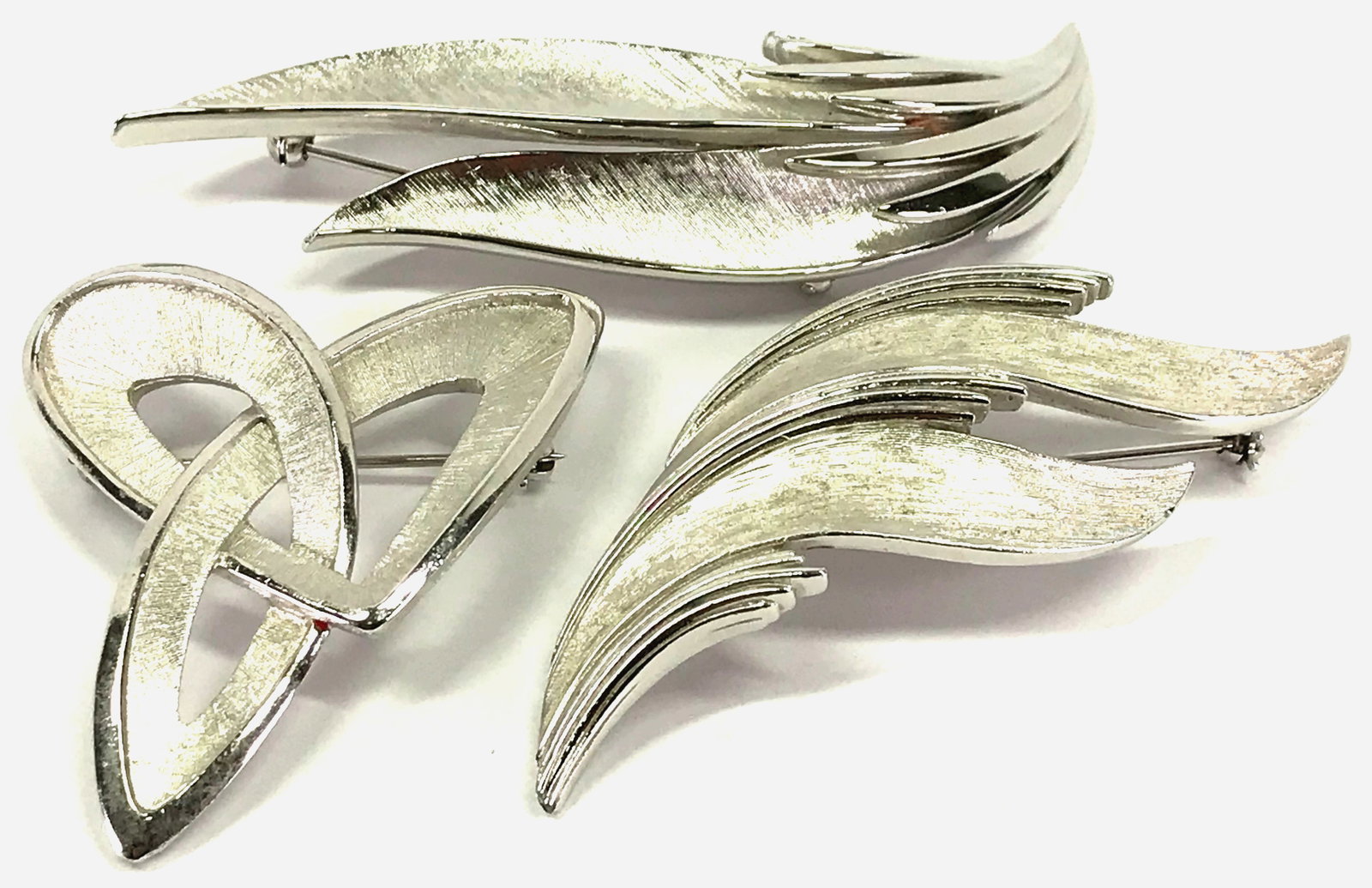 Vintage Crown Trifari brush & polish silvertone metal 3 pin brooches: Vintage Crown Trifari brush & polish silvertone metal 3 pin brooches. The 3 are signed. For measures please refer to the picture taken with a measuring tape. Weight: 58 Grams. This is a NO RESERVE AUC