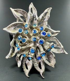 Vintage brutalist blue rhinestones brushed silvertone flower brooch.: Vintage brutalist blue rhinestones brushed silvertone metal flower pin brooch. Unmarked. For measures please refer to the pictures that were taken with a measuring tape. Weight: 20 Grams. This is a NO