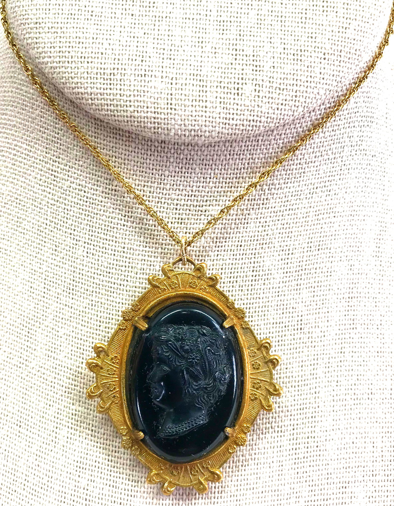 Antique black celluloid cameo goldtone metal locket pendant: Antique black celluloid cameo goldtone metal locket pendant. Unmaked Gold filled chain marked 1/20 14K GF For measures please refer to the picture taken with a measuring tape. Weight: 11 Grams. This i