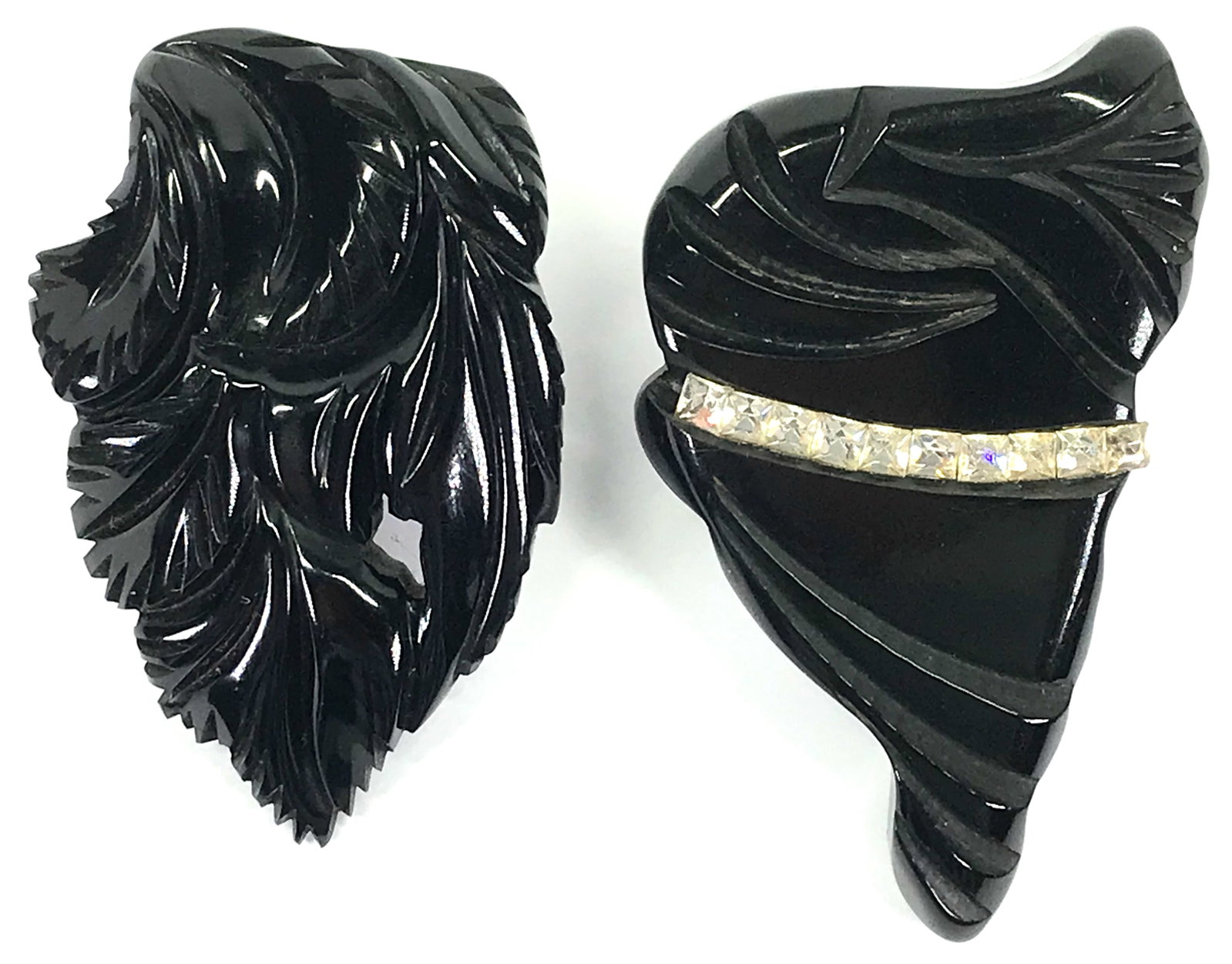 Antique art deco black galalith clip brooches: Carved black galalith leaves clip brooch .Original patina. Scuffs. Clip does not close tight. Clear crystals carved black galalith silvertone metal clip fur dress clip brooch.Original patina. Scuffs. 