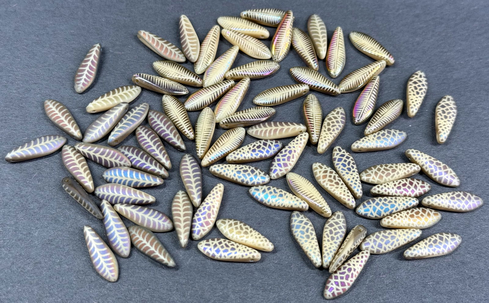 Assorted Czech Glass Laser Etched Dagger beads. Lot of 74.: Assorted Czech Glass Laser Etched Dagger beads. Lot of 74. For measures please refer to the pictures taken with a measuring tape. Weight: 25 Grams. This is a NO RESERVE AUCTION: there are no hidden or