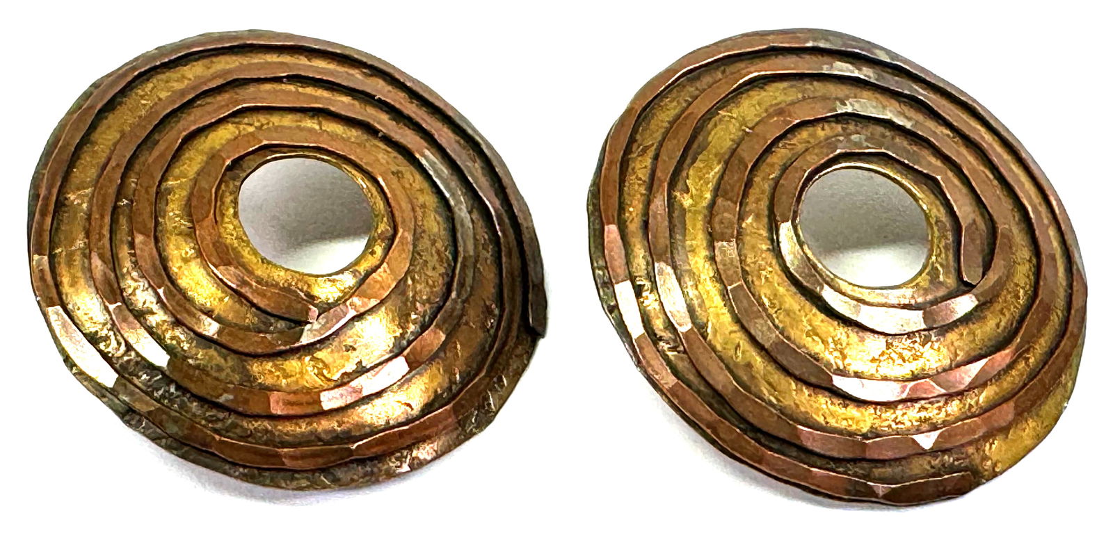 Vintage brutalist hammered bronze & copper spiral rounded large stud earrings.: Vintage brutalist hammered bronze & copper spiral rounded large stud earrings. Unmarked. Silvertone push backs. For measures please refer to the pictures taken with a measuring tape. Weight: 17 Grams.