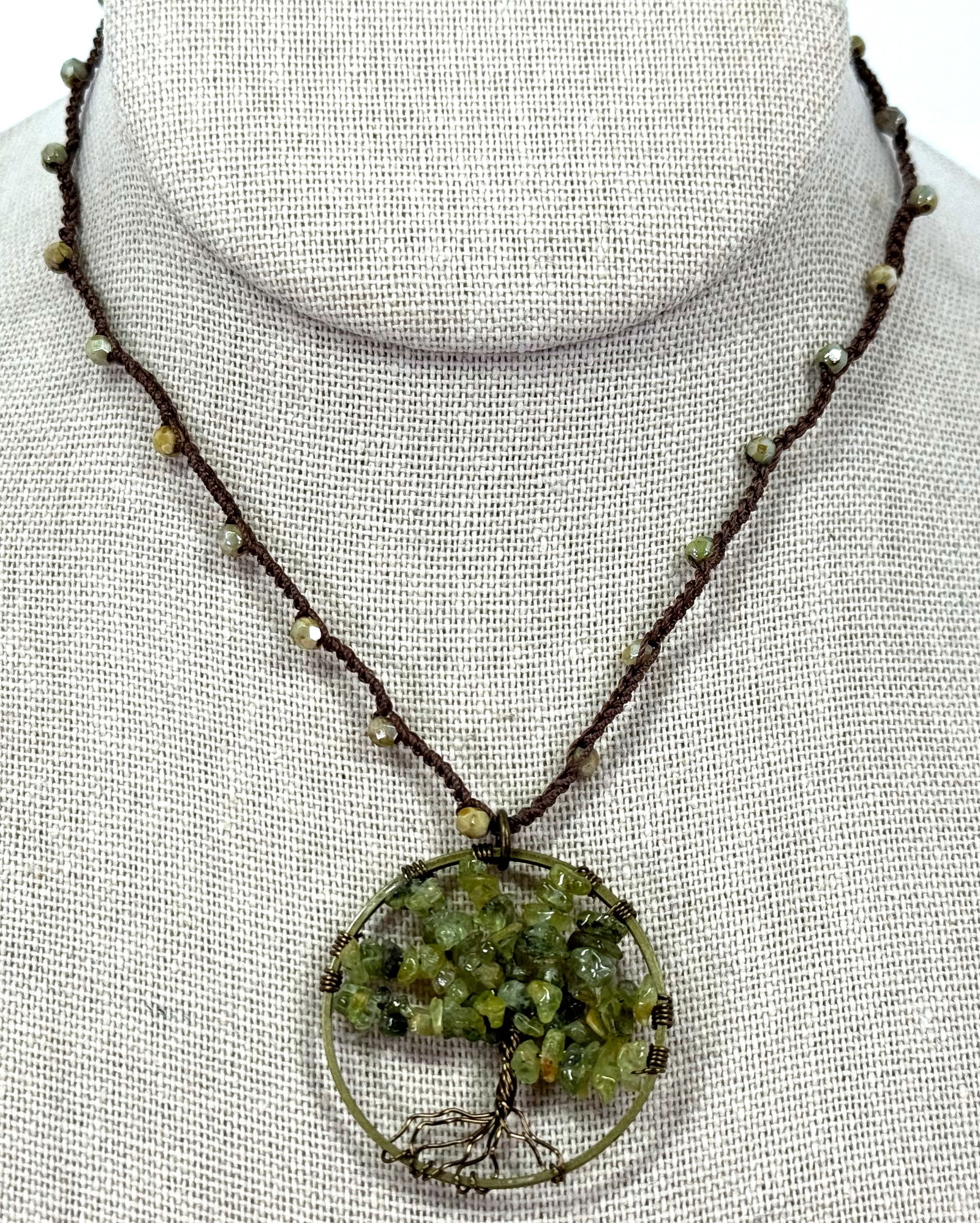 Edith Meriwether green stones & metal tree of life pendant woven strap necklace.: Edith Meriwether green stones & metal tree of life pendant with woven strap necklace. Unused with tag, For measures please refer to the pictures taken with a measuring tape. Weight: 9 Grams. This is a