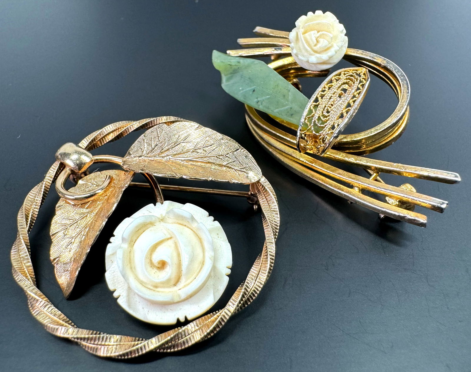 Vintage flower & jade leaf gold plated & 14K gold filled rounded pin brooches.: Vintage bone flower & jade leaf gold plated & 14K gold filled rounded pin brooches. The one with the jade leaf is unmarked, the other one is marked Inc 14K G F. For measures please refer to the pictur