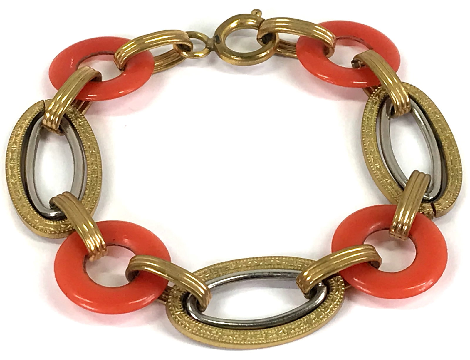 Antique art deco coral color galalith donuts metal bracelet.: Antique art deco coral color galalith donuts silvertone & goldtone metal bracelet. For measures please refer to the picture taken with a measuring tape. Weight: 22 Grams. This is a NO RESERVE AUCTION: