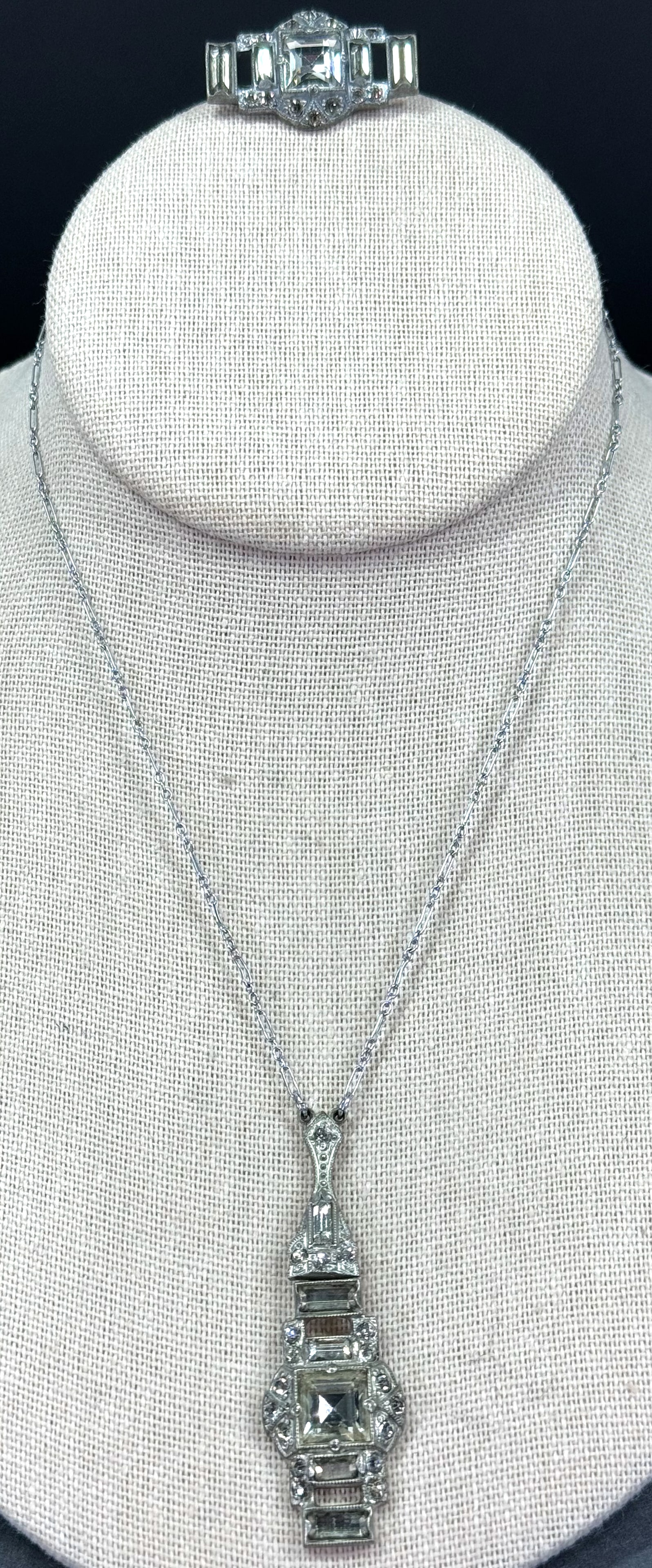 Antique art deco clear crystal silvertone pot metal lavalier necklace and pin brooch set: Antique art deco clear crystal silvertone pot metal lavalier necklace and pin brooch set . Unmarked. For measures please refer to the pictures taken with a measuring tape. Weight: 13 Grams all. This i
