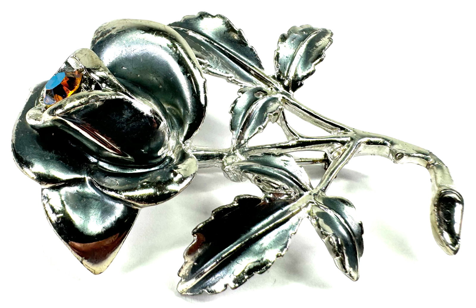 Vintage Florenza AB crystal rose flower & leaves silvertone metal pin brooch.: Vintage Florenza AB crystal rose flower & leaves silvertone metal pin brooch. Marked. For measures please refer to the pictures that were taken with a measuring tape. Weight: 26 Grams. This is a NO RE