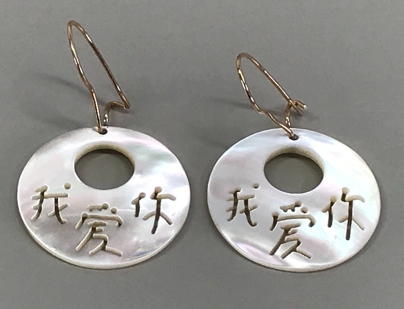 Chinese carved "I LOVE YOU" in MOP dangle 14K yellow gold hook earrings.: Chinese carved "I LOVE YOU" in mother of pearl MOP dangle 14K yellow gold hook earrings. Marked 14 K on hooks. For measures please refer to the picture taken with a measuring tape. Weight: 3.56 Grams.