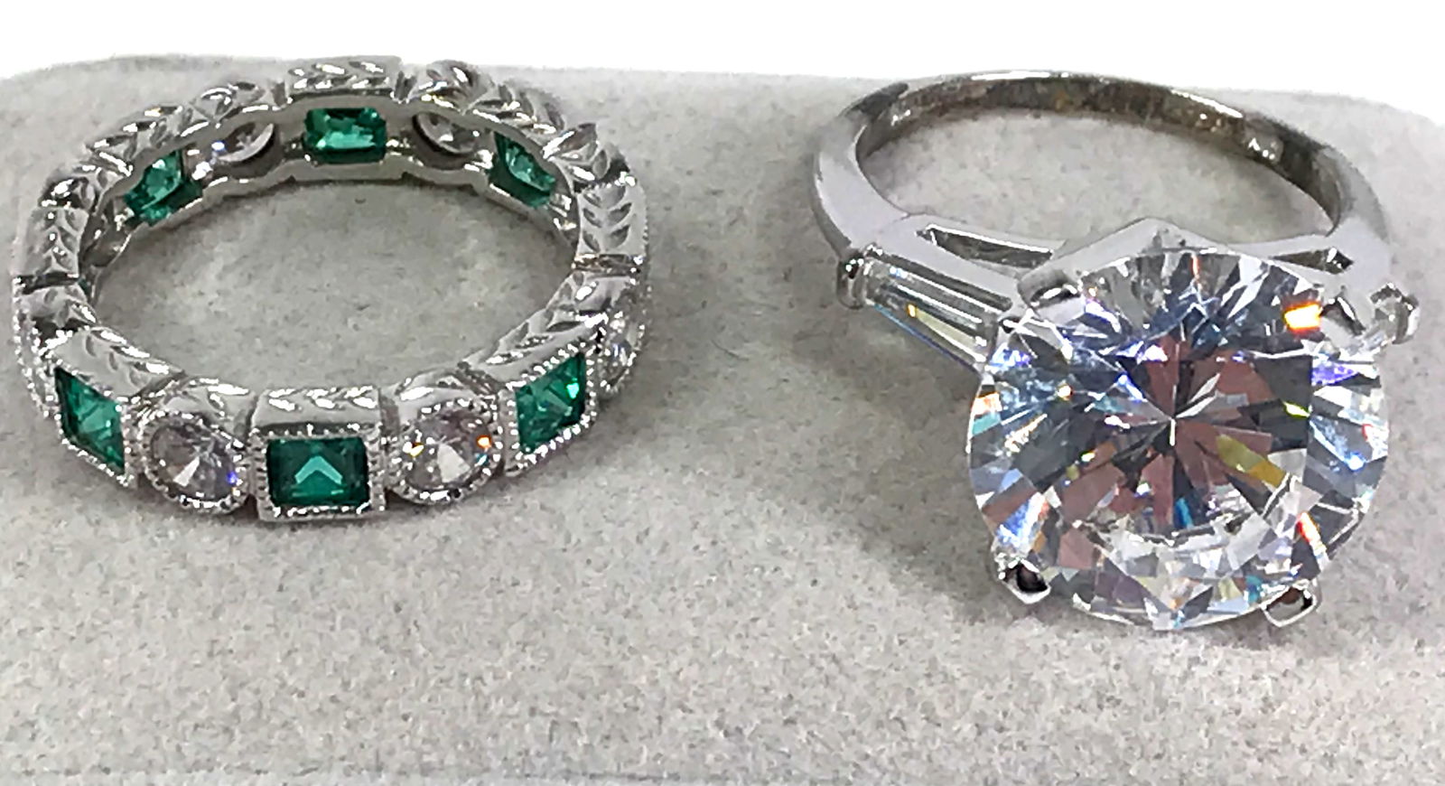 Sterling Silver Crystals Eternity & Gold plated Solitaire Ring: Green and clear crystals sterling silver eternity ring marked 925. White gold plated clear crystals solitaire ring with an unreadable mark. It has a crystal on each side. Both are approx size 6, pleas