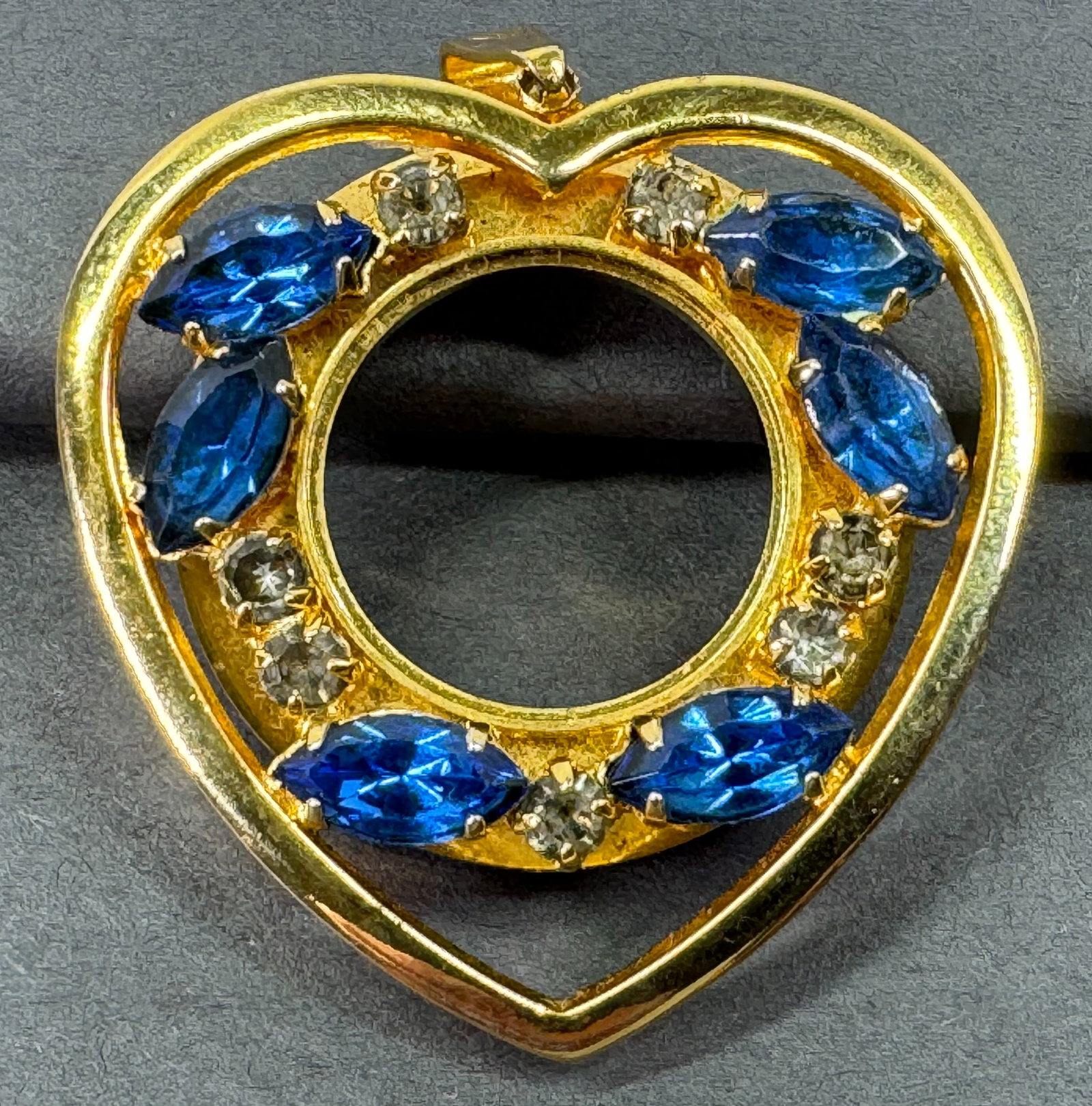 Vintage blue crystals & clear rhinestones goldtone metal heart shaped pendant.: Vintage blue crystals & clear rhinestones goldtone metal heart shaped pendant. Space for a watch. It has a diamond shaped mark on bail. Hole on bottom. For measures please refer to the pictures taken 