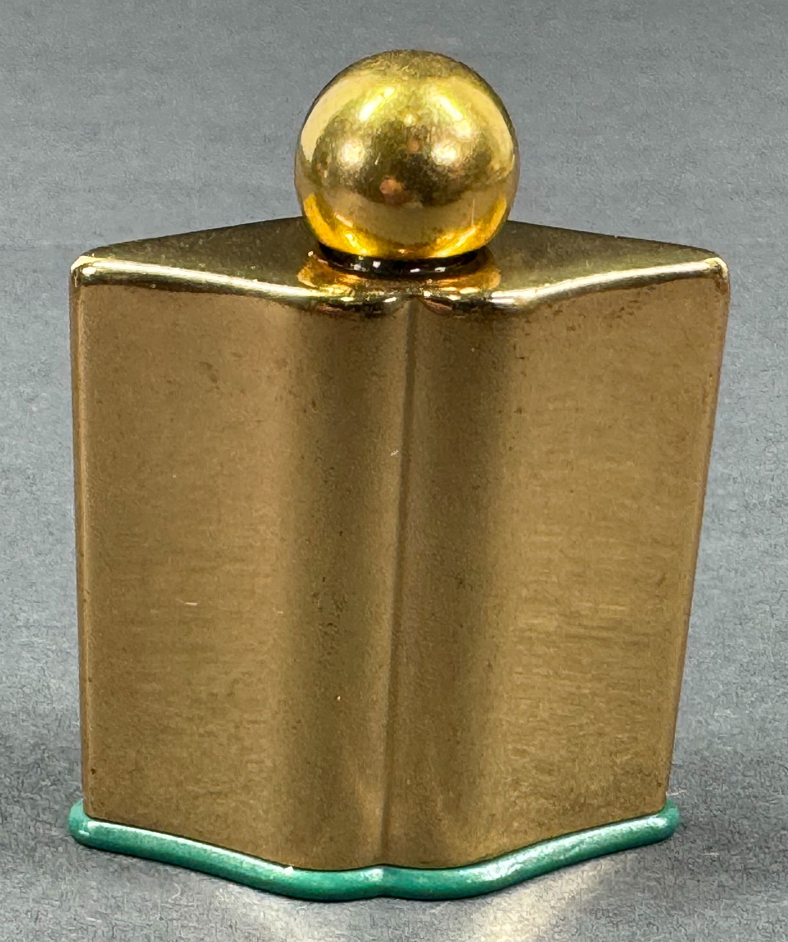 Vintage Emeraude Coty lip shaped bottom golden metal encased glass miniature perfume bottle. (1 of 9)