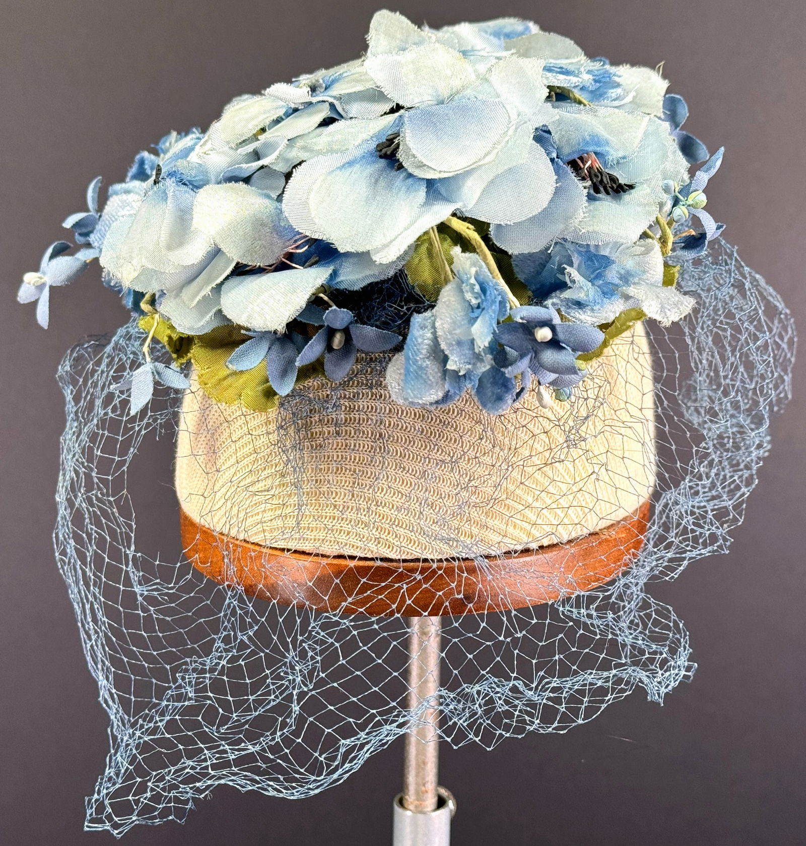 Vintage Miss Sally Victor New York lavender fabric flowers & leaves hat with net.: Vintage Miss Sally Victor New York lavender fabric flowers & leaves hat with net. Fabric label. 2 plastic combs. It measures around 6 inches in diameter. This is a NO RESERVE AUCTION: there are no hid
