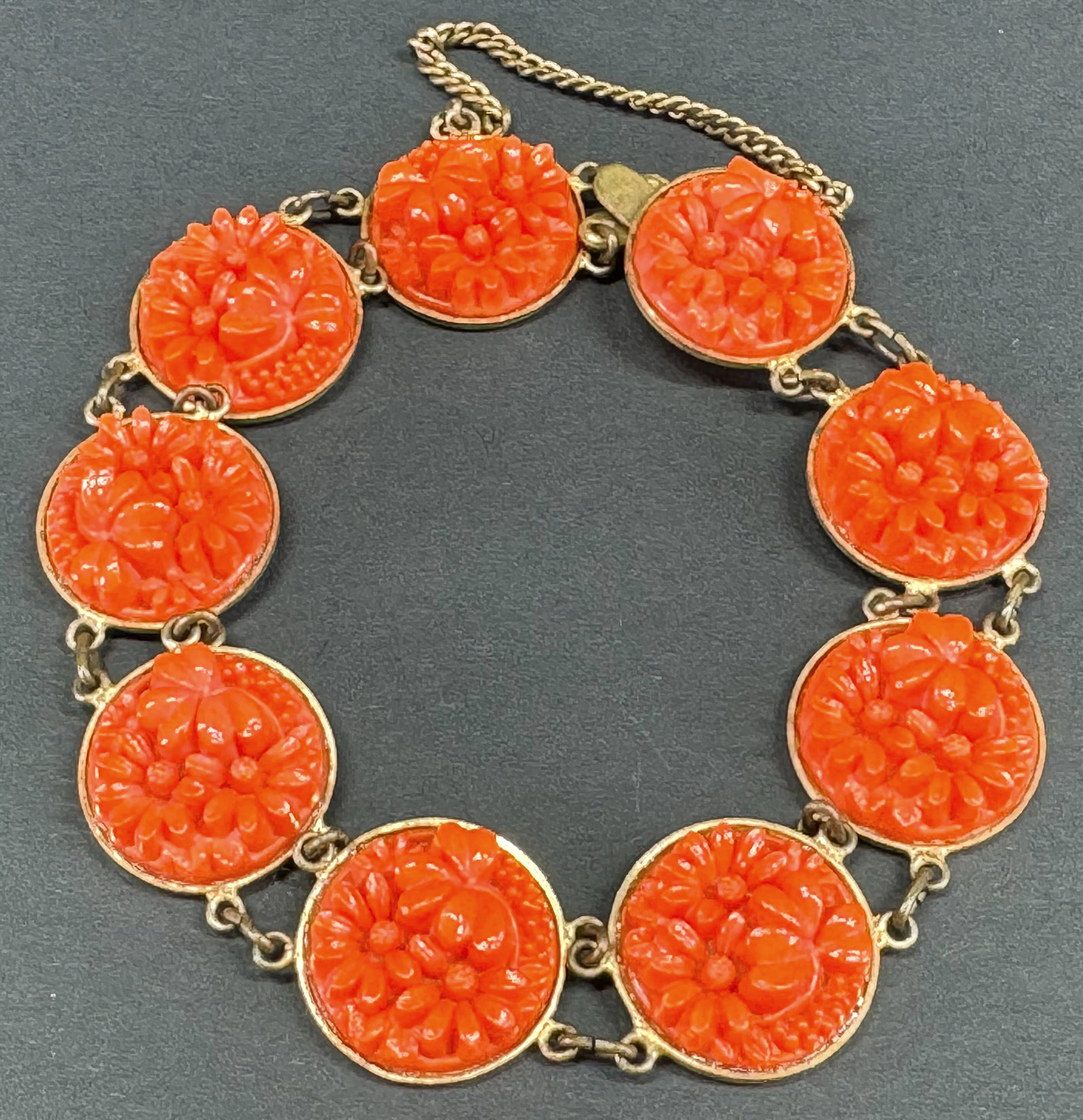 Vintage Japanese coral color celluloid flowers and leaves goldtone metal bracelet.: Vintage Japanese coral color celluloid flowers and leaves goldtone metal bracelet. Marked Japan. Security chain. For measures please refer to the pictures taken with a measuring tape. Weight: 35 Grams