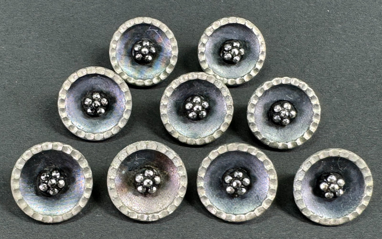 Antique Edwardian cut steel flower wavy rim metal buttons. Lot of 9: Antique Edwardian cut steel flower wavy rim metal buttons. Lot of 9 . For measures please refer to the pictures taken with a measuring tape. Weight: 8 Grams. This is a NO RESERVE AUCTION: there are no