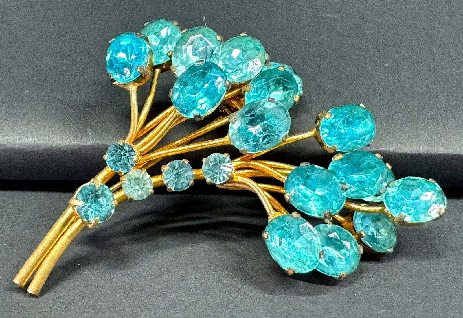 Vintage Czech open back turquoise crystals goldtone metal flowers bouquet brooch. Marked: Vintage Czech open back turquoise crystals goldtone metal flowers bouquet brooch. Marked For measures please refer to the picture taken with a measure tape. Weight : 17 Grams. This is a NO RESERVE AUC