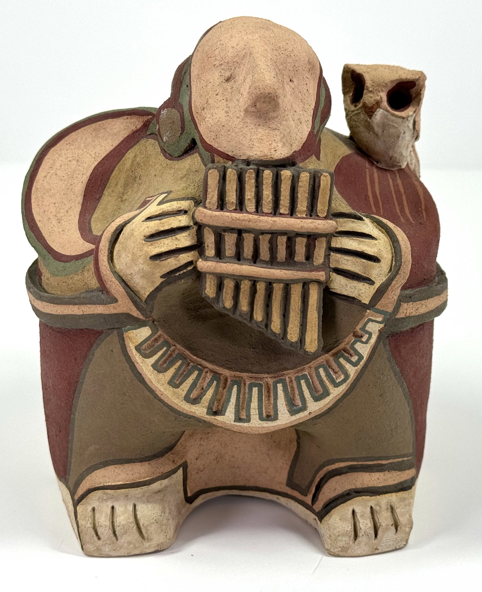 Vintage Argentinian Folk Art artisan hand painted Coya with quena & owl pottery figurine: Vintage Argentinian Folk Art artisan hand crafted and painted Coya playing the quena with an owl on his shoulder pottery figurine. Signed Seri Arg. It measures 5 inches tall and 4 1/4 inches widest. T