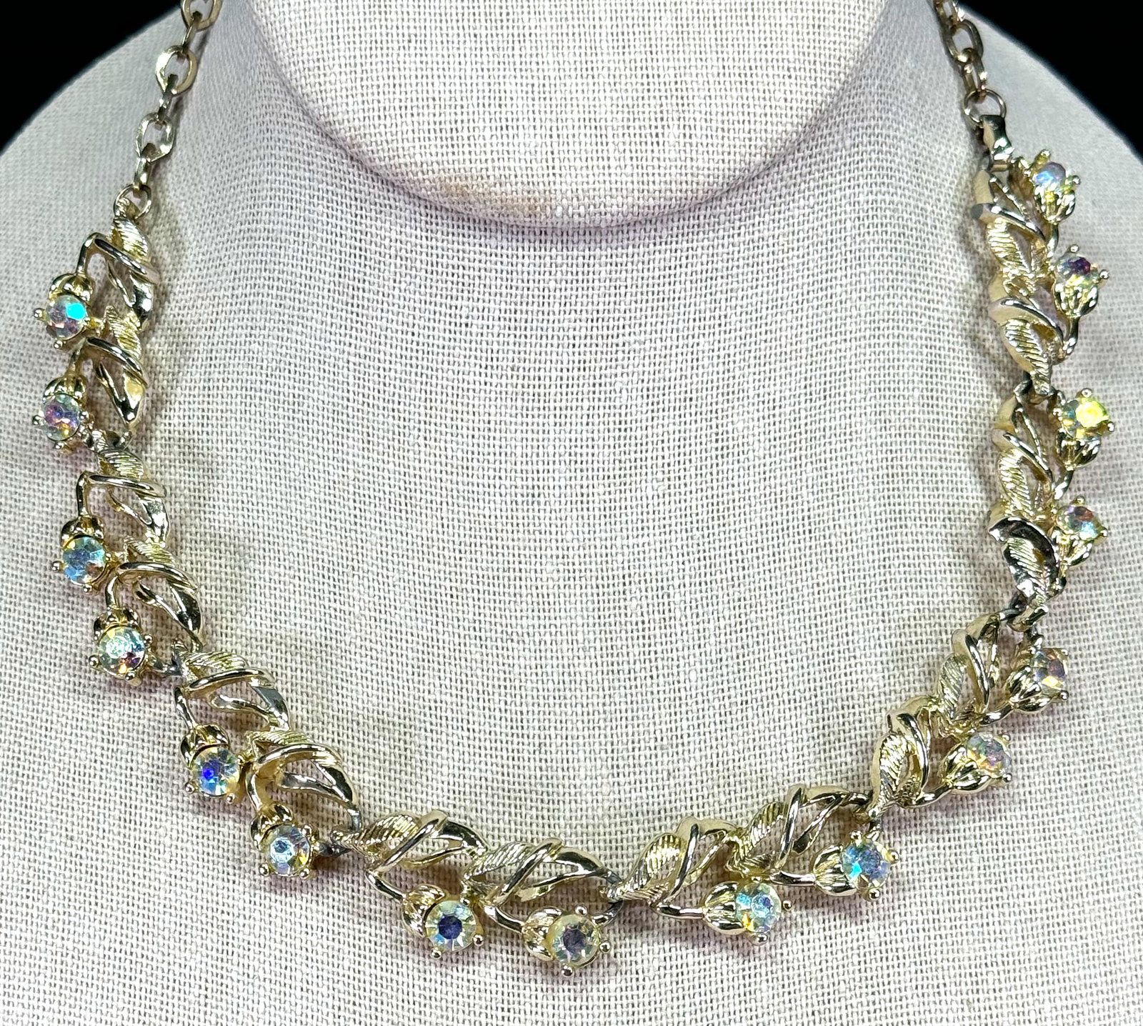 Vintage AB crystals goldtone metal collar flower & leaves necklace.: Vintage AB crystals goldtone metal collar flower & leaves necklace. For measures please refer to the pictures taken with a measuring tape. Weight: 39 Grams. This is a NO RESERVE AUCTION: there are no 