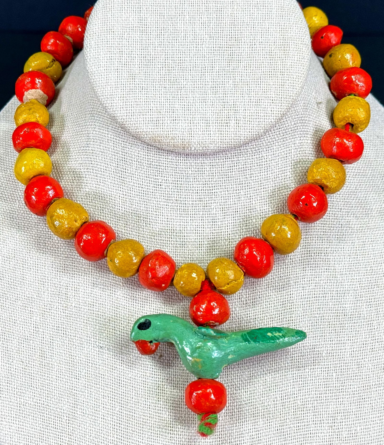 Vintage Guatemalan ethnic handmade colorful clay parrot & beads with woll strap necklace .: Vintage Guatemalan ethnic handmade colorful clay parrot & beads with woll strap necklace . Unmarked For measures please refer to the pictures taken with a measuring tape.Weight: 63 Grams. This is a NO