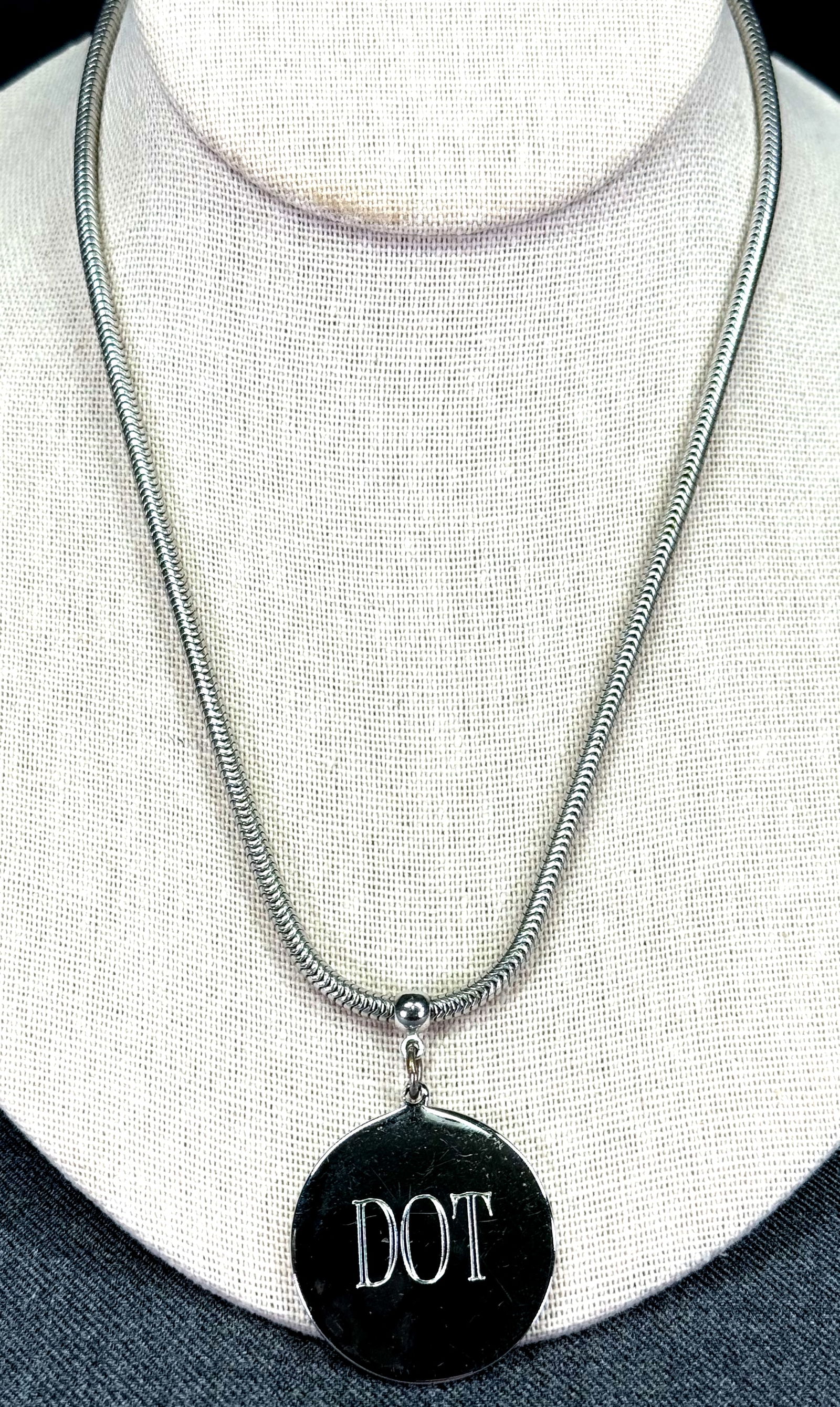 Vintage Coro Pegasus engraved DOT silvertone metal medal and snake chain strap necklace.: Vintage Coro Pegasus engraved DOT silvertone metal medal and snake chain strap necklace. Marked . For measures please refer to the pictures taken with a measuring tape. Weight: 14 Grams. This is a NO