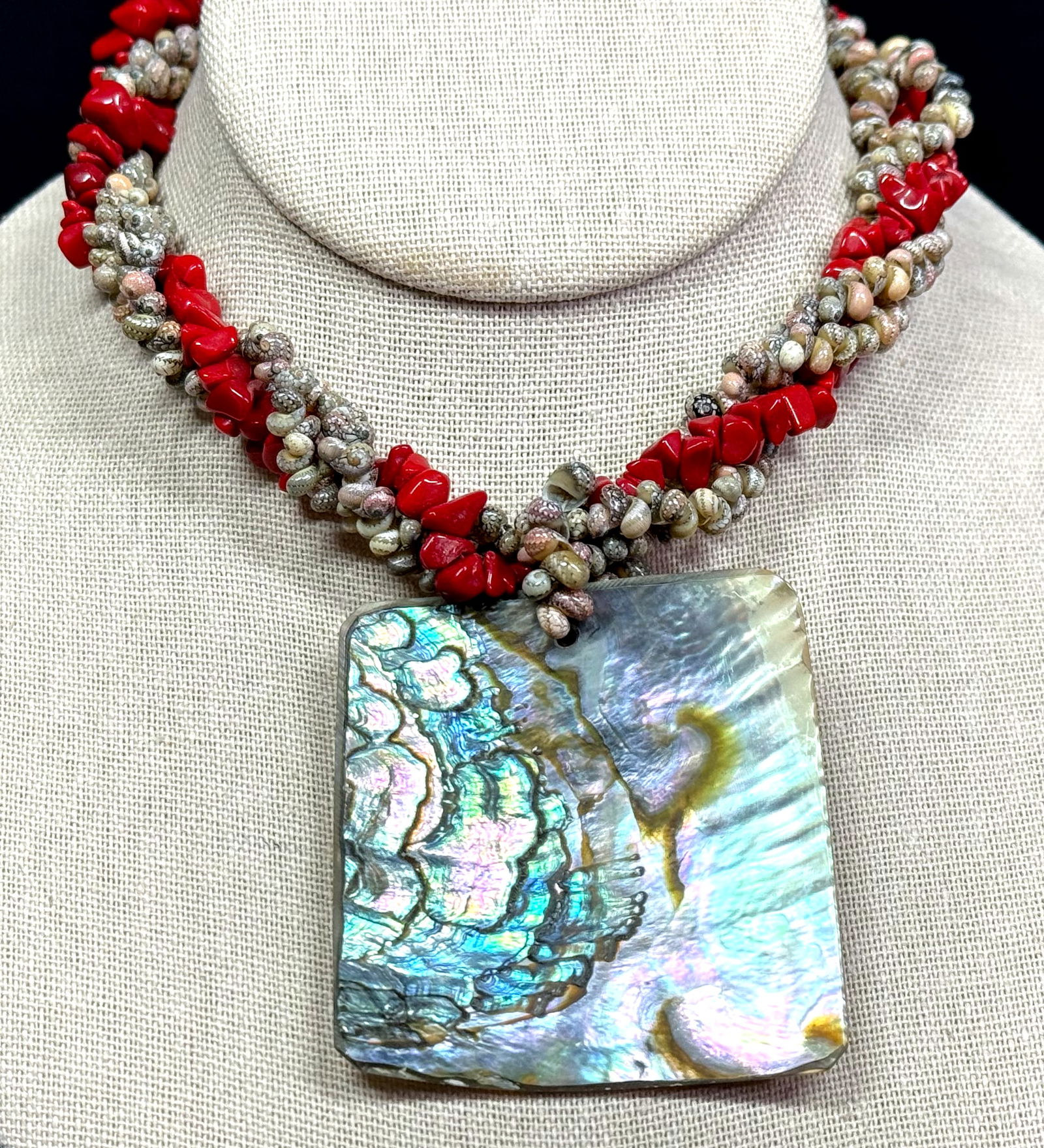 Vintage ethnic style abalone medallion woven coral color glass & tiny shells necklace.: Vintage ethnic style abalone medallion woven coral color glass & tiny shells necklace. Metal clasp. Unmarked. For measures please refer to the pictures taken with a measuring tape. Weight: 110 Grams.