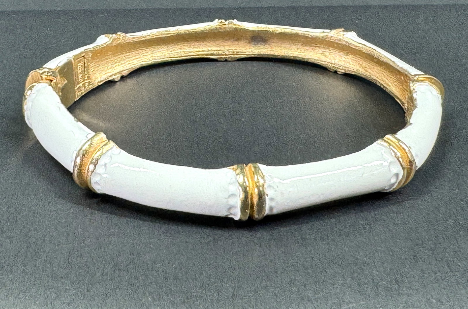 Vintage Crown Trifari white enamel goldtone metal cane clamper bracelet: Vintage Crown Trifari white enamel goldtone metal cane clamper bracelet. Marked. For measures please refer to the pictures taken with a measuring tape. Weight: 32 Grams. This is a NO RESERVE AUCTION: 