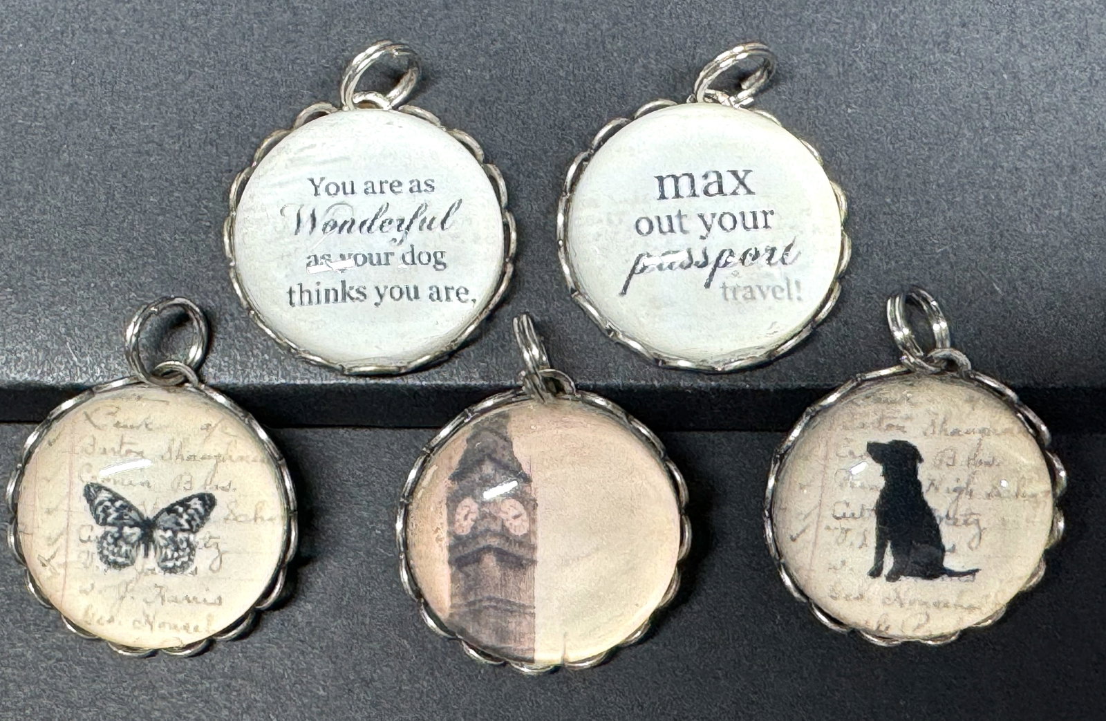 Vintage Niquea.D butterfly , dog, The Big Ben & others dome pendants. Lot of 5: Vintage Niquea.D butterfly + Max Out your Passport Travel! + black dog + You are as wonderful as your dog thinks you are + Big Ben dome glass silvertone metal pendants. Lot of 5. Unmarked. For measure