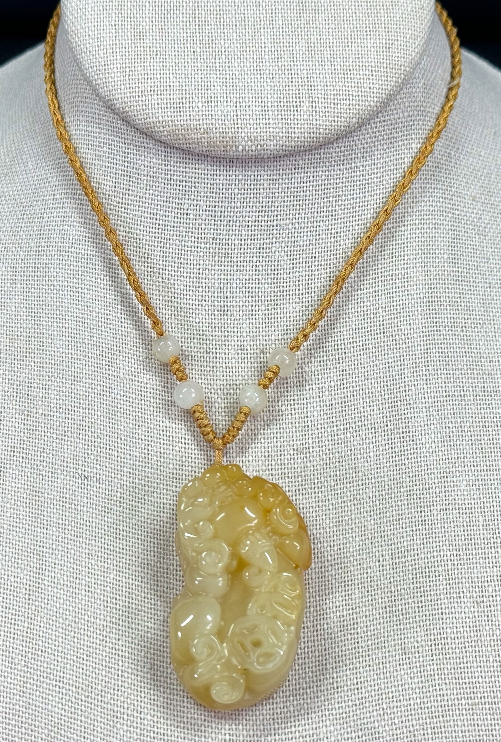 Vintage Chinese carved yellow jadeite Pixiu pendant with silky adjustable strap necklace.: Vintage Chinese carved yellow jadeite Pixiu pendant with silky adjustable strap necklace. Unmarked. For measures please refer to the pictures taken with a measuring tape. Weight: 25 Grams . This is a