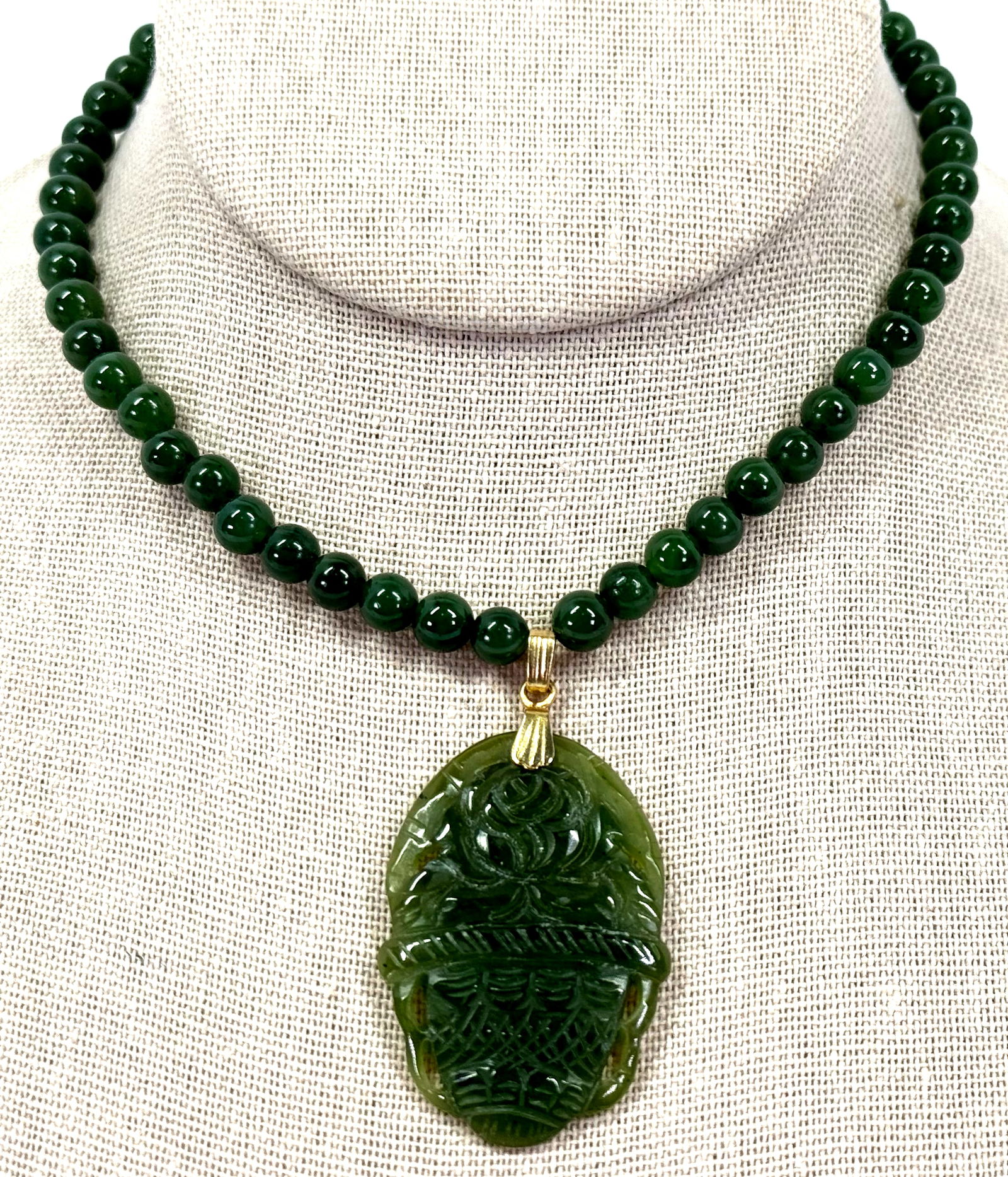 Vintage Chinese carved pot & flower medallion beaded green jade necklace.: Vintage Chinese carved pot & flower medallion beaded green jade necklace. Goldtone metal clasp. For measures please refer to the pictures taken with a measuring tape. Weight: 29 Grams. This is a NO RE