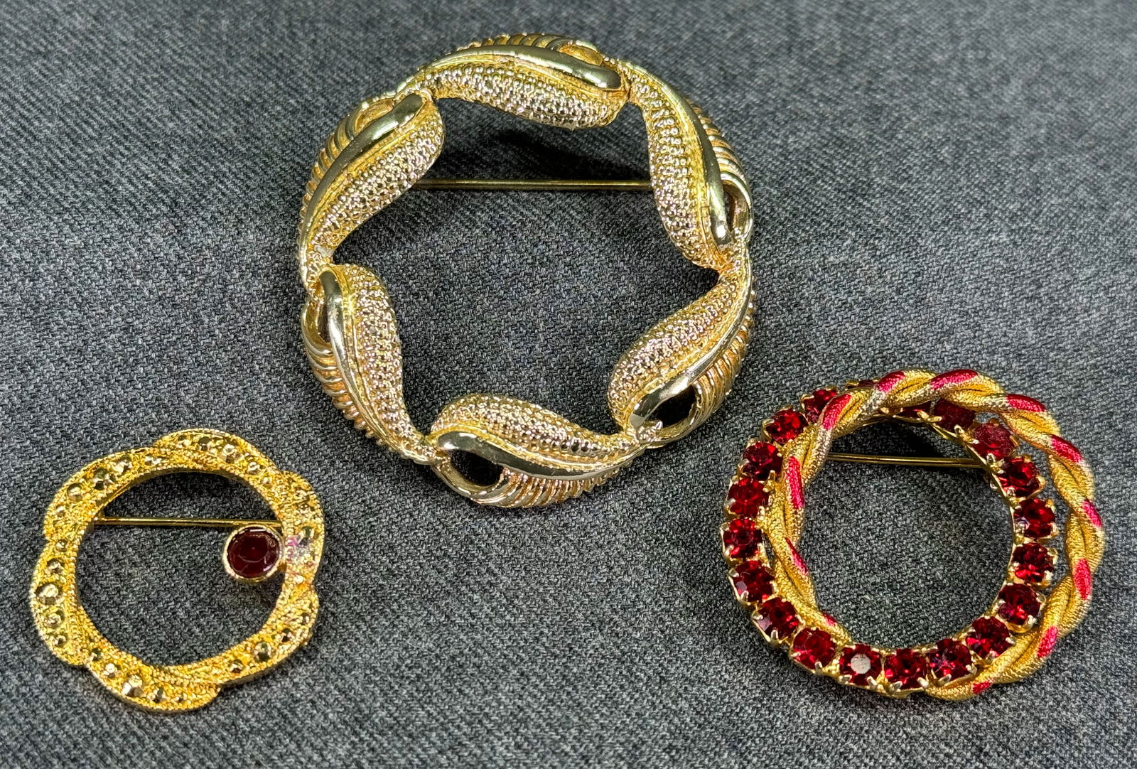 Vintage Coro Pegasus & two unbranded jeweled crystals goldtone metal wreath pin brooches.: Vintage Coro Pegasus & two unbranded jeweled crystals goldtone metal wreath pin brooches. Lot of 3. The Coro is marked and the other two are unmarked. For measures please refer to the pictures taken w