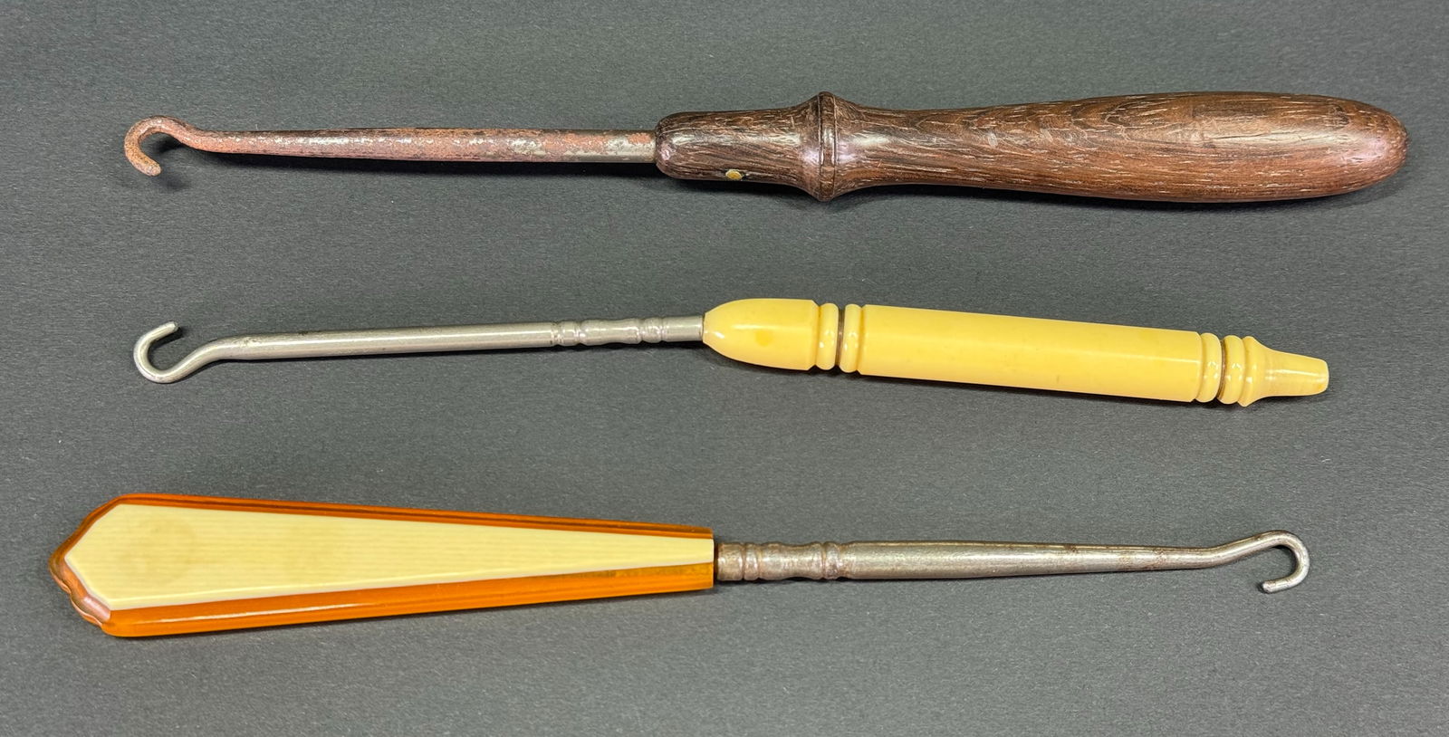 Antique assorted celluloid, wood and metal shoe,  gloves button hooks. Lot of 3 . (1 of 5)