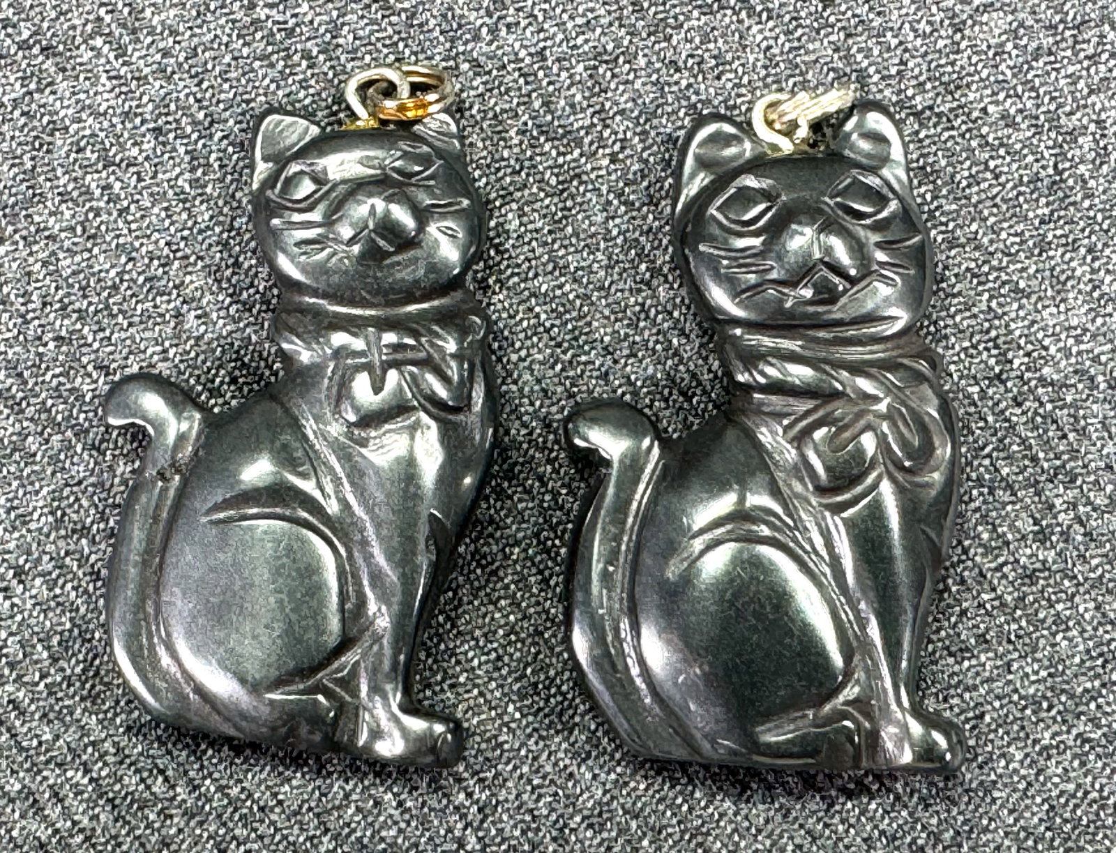 Carved hematite cat kitten pendants. Lot of 2: Carved hematite cat kitten pendants. Lot of 2. Unmarked. For measures please refer to the pictures taken with a measuring tape. Weight: 23 Grams. This is a NO RESERVE AUCTION: there are no hidden or c