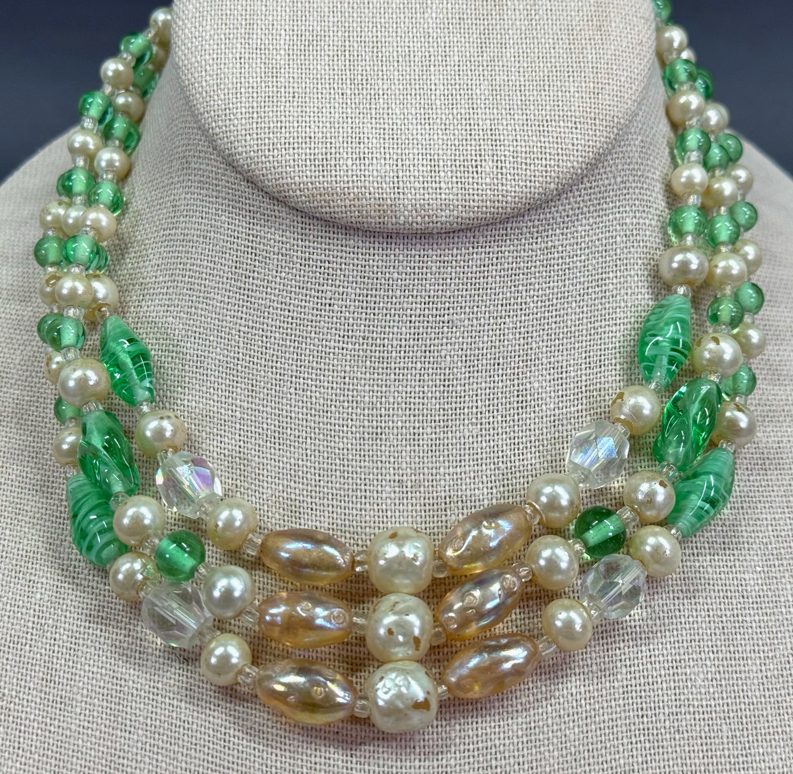 Vintage Japanese pearly, green & clear glass AB crystal beads 3 strands collar necklace.: Vintage Japanese pearly, green & clear glass AB crystal beads 3 strands collar necklace. Marked Japan on clasp. For measures please refer to the pictures taken with a measuring tape. Weight: 60 Grams.