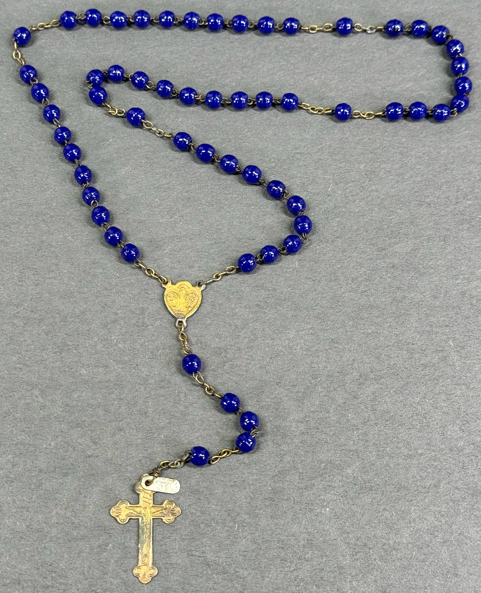 Antique French Instrument of the Passion Crucifix, Mary heart shaped medal blue glass rosary: Antique French Goldtone metal Instrument of the Passion Crucifix, Mary heart shaped medal blue glass rosary. France tag For measures please refer to the pictures taken with a measuring tape. Weight: 1