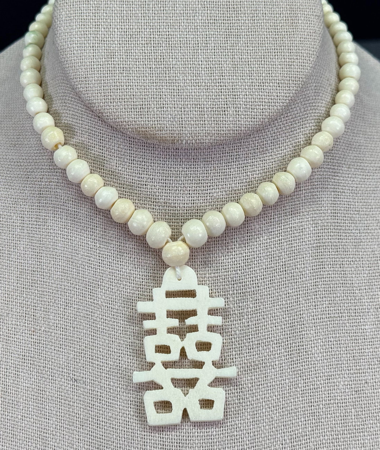Vintage Chinese carved bone double happiness pendant beaded strap necklace: Vintage Chinese carved bone double happiness pendant beaded strap necklace . Unmarked. For measures please refer to the pictures taken with a measuring tape. Weight: 22 Grams. This is a NO RESERVE AUC