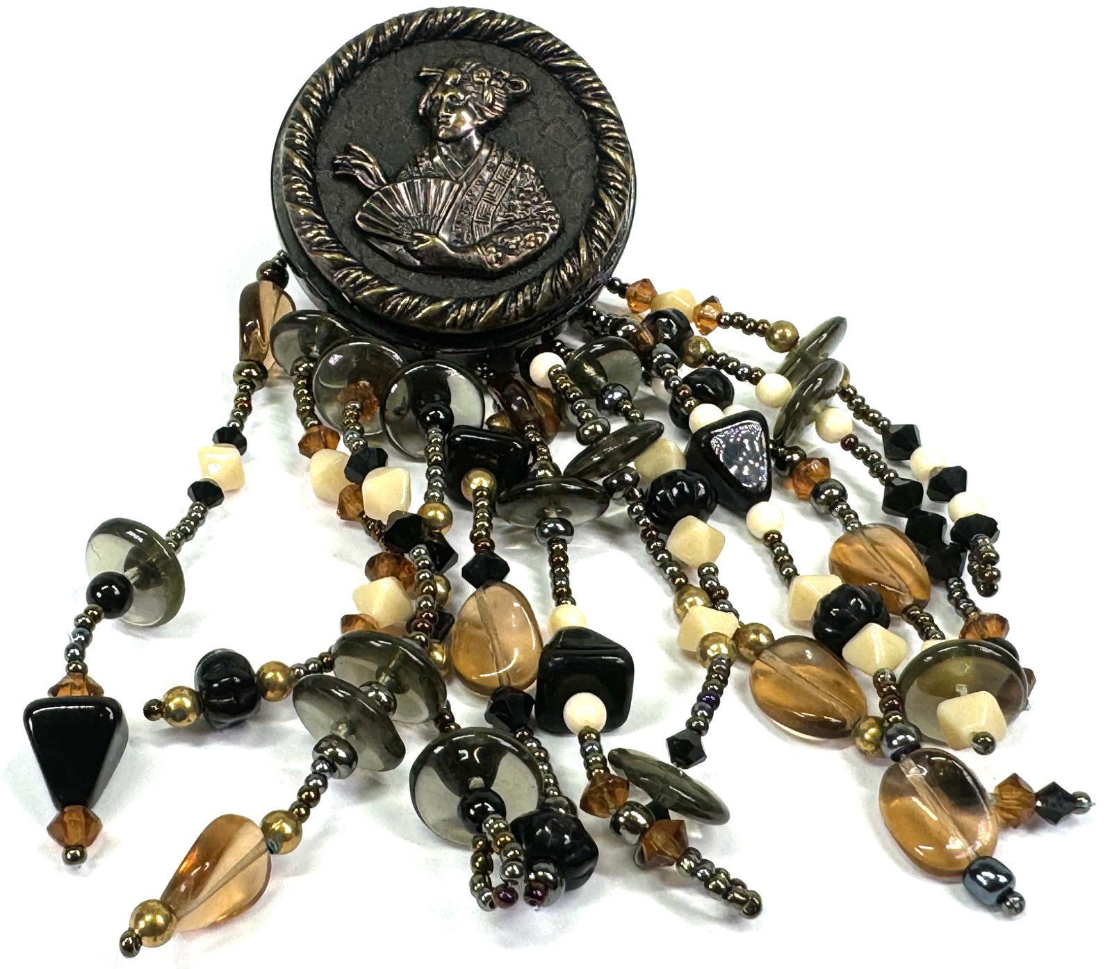 Vintage artsy geisha with fan metal celluloid button with glass beaded fringe large brooch: Vintage artsy geisha with fan metal & black celluloid button with glass beaded fringe large brooch . For measures please refer to the picture taken with a measuring tape. Weight: 50 Grams. This is a N