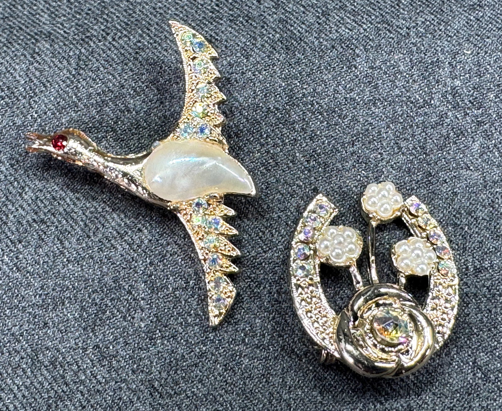 Vintage AB crystals pearly thermoplastic belly & flowers golden flying bird & bouquet pin brooches: Vintage AB crystals pearly thermoplastic belly & flowers golden flying bird & bouquet pin brooches. Unmmarked. For measures please refer to the pictures taken with a measuring tape. Weight: 22 Grams.