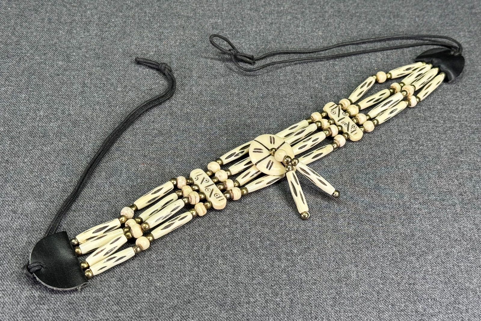 Vintage Native American Style Rosetta medal hairpipe buffalo bone & golden beaded necklace: Vintage Native American Style Rosetta medal hairpipe buffalo bone & golden beaded necklace. Unmarked. For measures please refer to the pictures taken with a measuring tape. Weight: 45 Grams. This is a