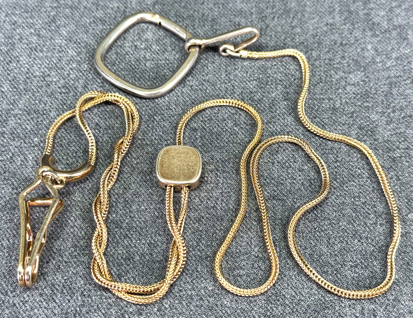 Vintage Swank goldtone metal pocket watch key holder chain fob with slider: Vintage Swank goldtone metal pocket watch key holder chain fob with slider. Marked. For measures please refer to the pictures taken with a measuring tape. Weight: 22 Grams. IN HOUSE Estimated* shippin
