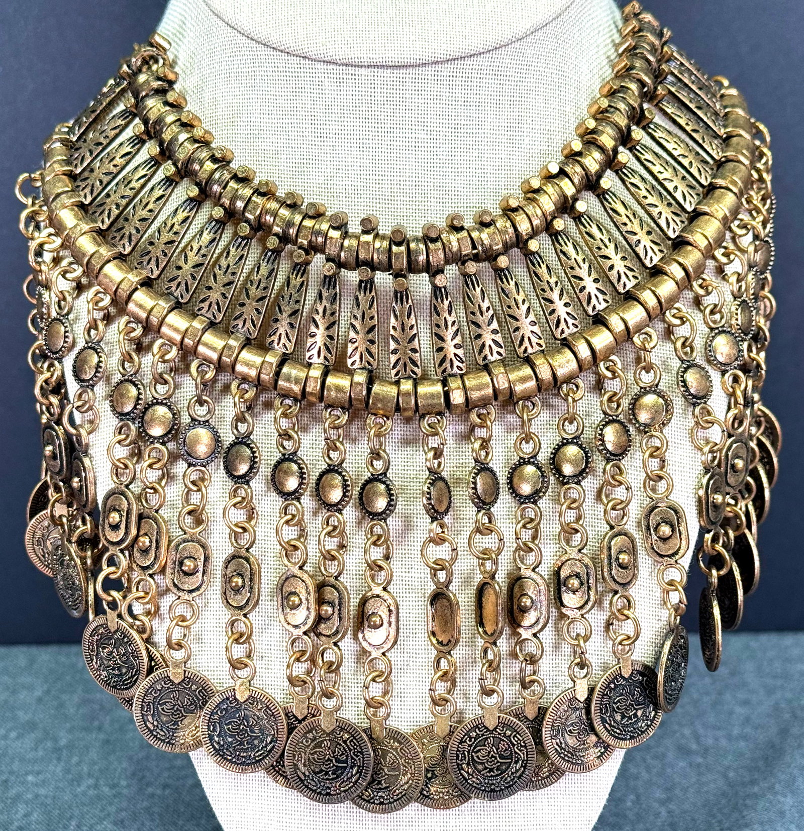 Ethnic tribal style coppertone metal coin dangles bib collar necklace: Ethnic tribal style coppertone metal coin dangles bib collar necklace. Unmarked. For measures please refer to the pictures taken with a measuring tape. Weight: 200 Grams. IN HOUSE Estimated* shipping 