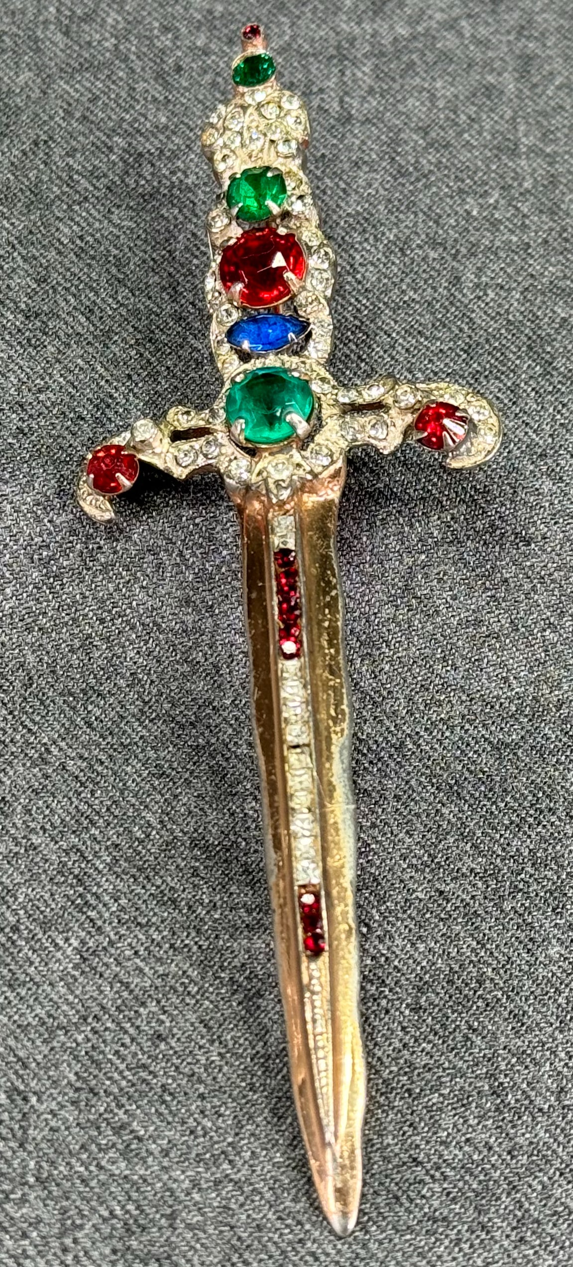 Vintage attributed to Corocraft color glass cabs & rhinestones gilt sterling huge sword pin brooch.: Vintage attributed to Corocraft color glass cabs & rhinestones gilt sterling huge sword pin brooch. Marked Sterling. For measures please refer to the pictures taken with a measuring tape. Weight: 20.3