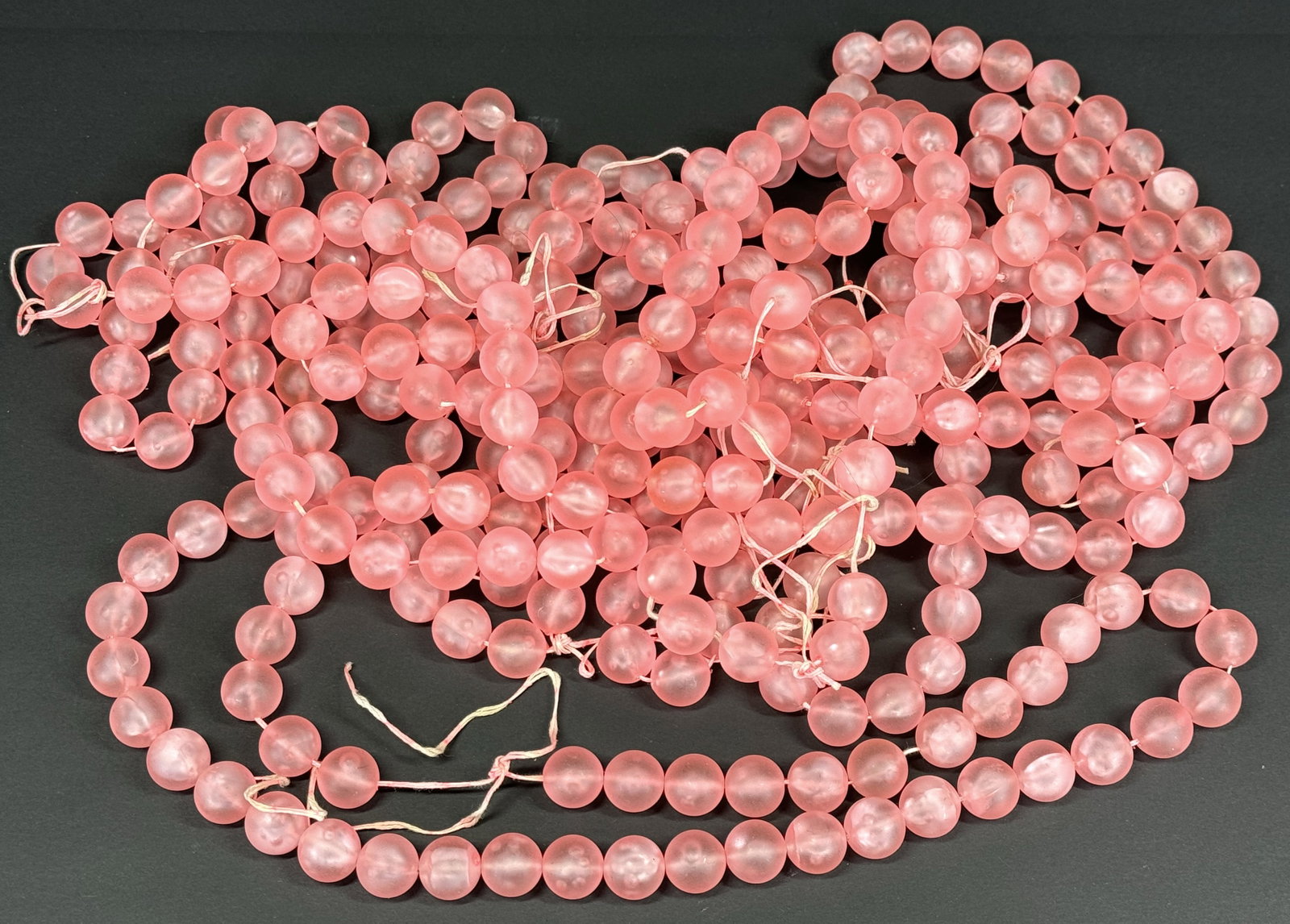 Vintage frosted pink plastic beads strands. Unused. 1 L & 10 Oz.: Vintage frosted pink plastic beads strands. Unused. 1 L & 10 Oz. For measures please refer to the pictures taken with a measuring tape. Weight: 730 Grams. This is a NO RESERVE AUCTION: there are no hi