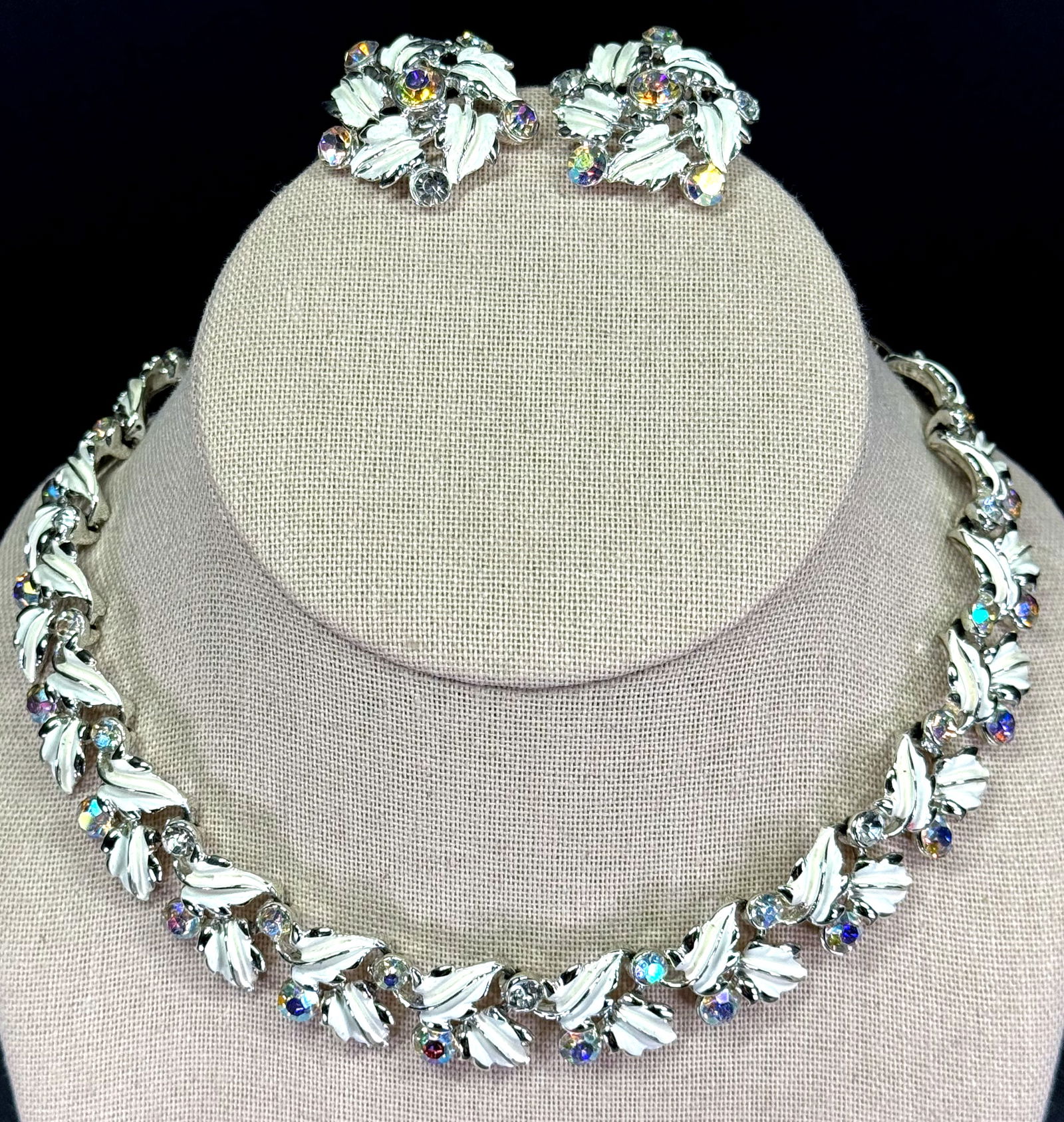 Vintage Coro style AB & clear crystals, creamy enamel goldtone metal leaves necklace & clip earrings: Vintage Coro style AB & clear crystals, creamy enamel goldtone metal leaves necklace & clip earrings. Unmarked. For measures please refer to the pictures taken with a measuring tape. Weight: 64 Grams.