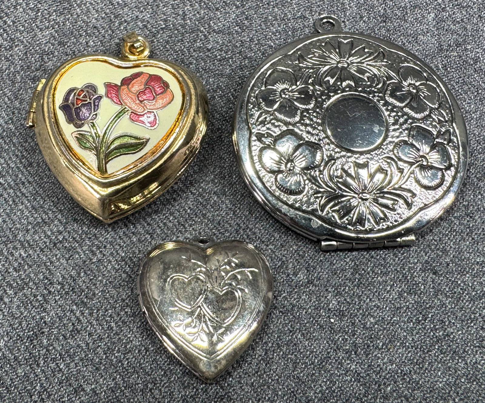 Vintage monogram space silvertone and cloisonne enamel flowers heart goldtone locket pendants: Vintage monogram space silvertone and cloisonne enamel flowers heart goldtone locket pendants . Unmarked. For measures please refer to the pictures taken with a measuring tape. Weight: 26 Grams IN HOU