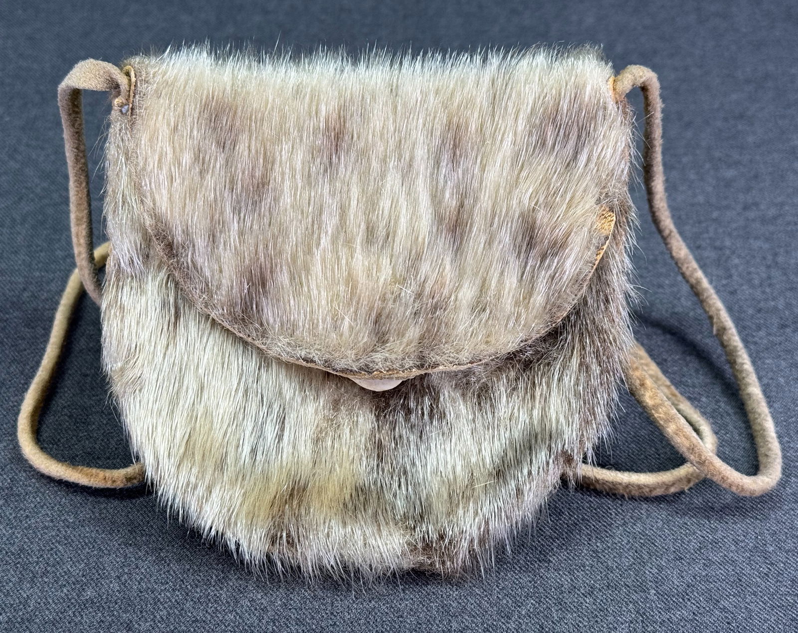 Vintage Inuit Pouch. Sealskin, leather, bone.: Vintage Inuit Pouch. Sealskin, leather, bone. Inscribed on the interior. For measures please refer to the pictures taken with a measuring tape. The strap measures 23 inches long. IN HOUSE Estimated* s